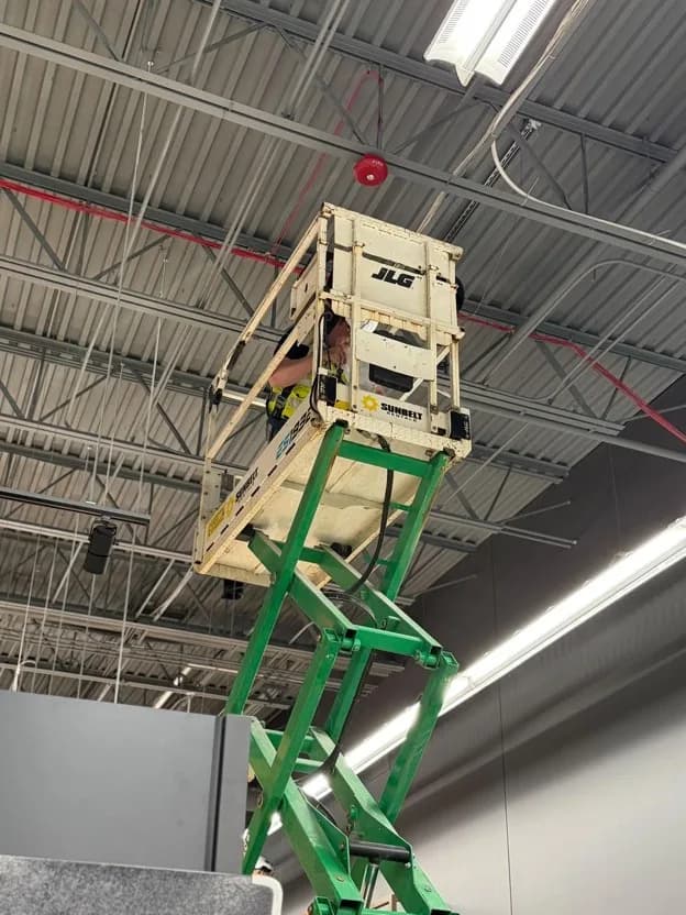 Point-to-point wireless bridge radios mounted on a rooftop antenna mast