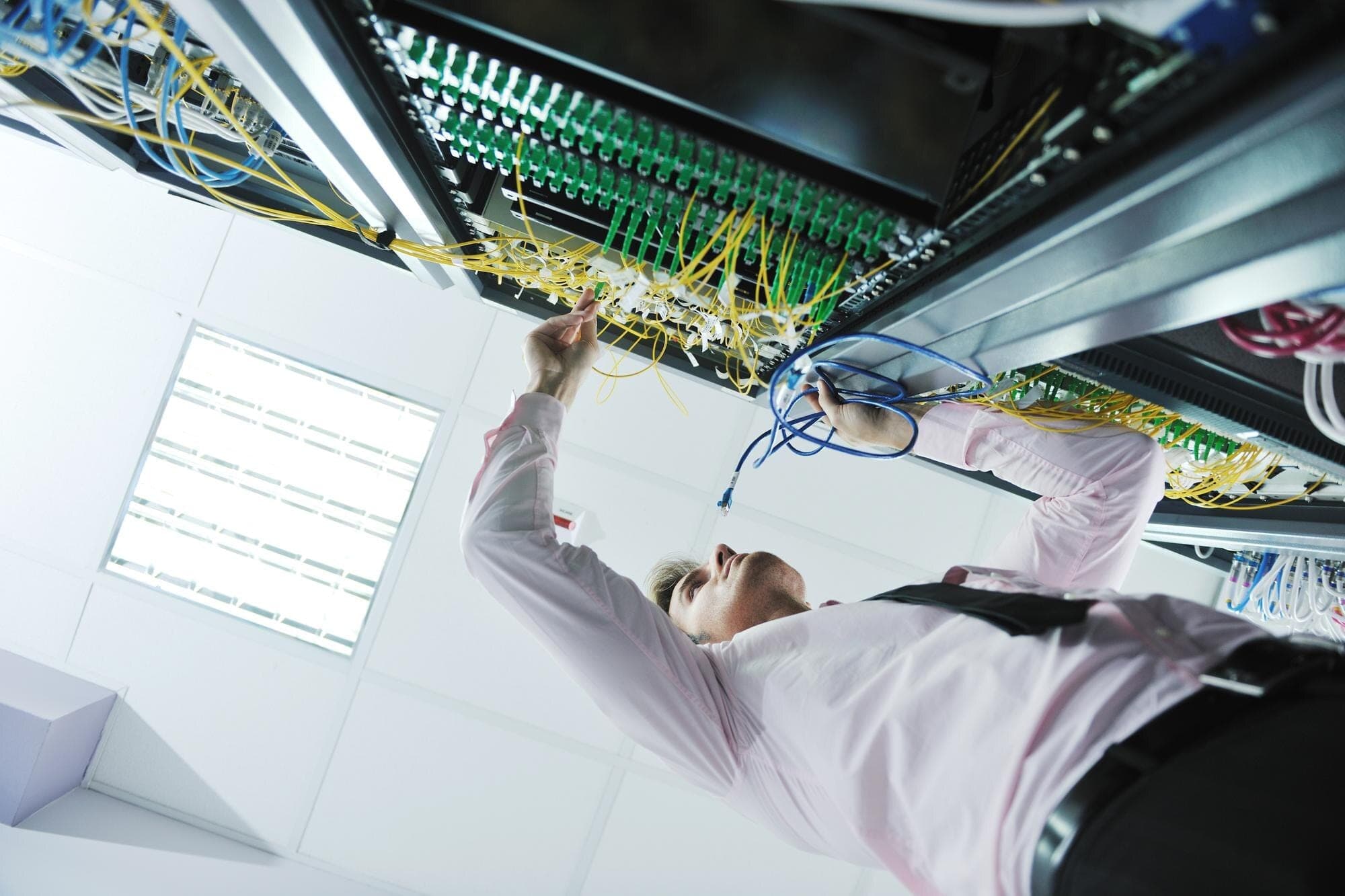 WZC engineer working on network core equipment in a data center